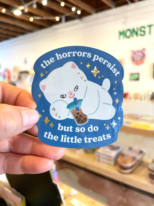 "the horrors persist but so do the little treats" vinyl sticker