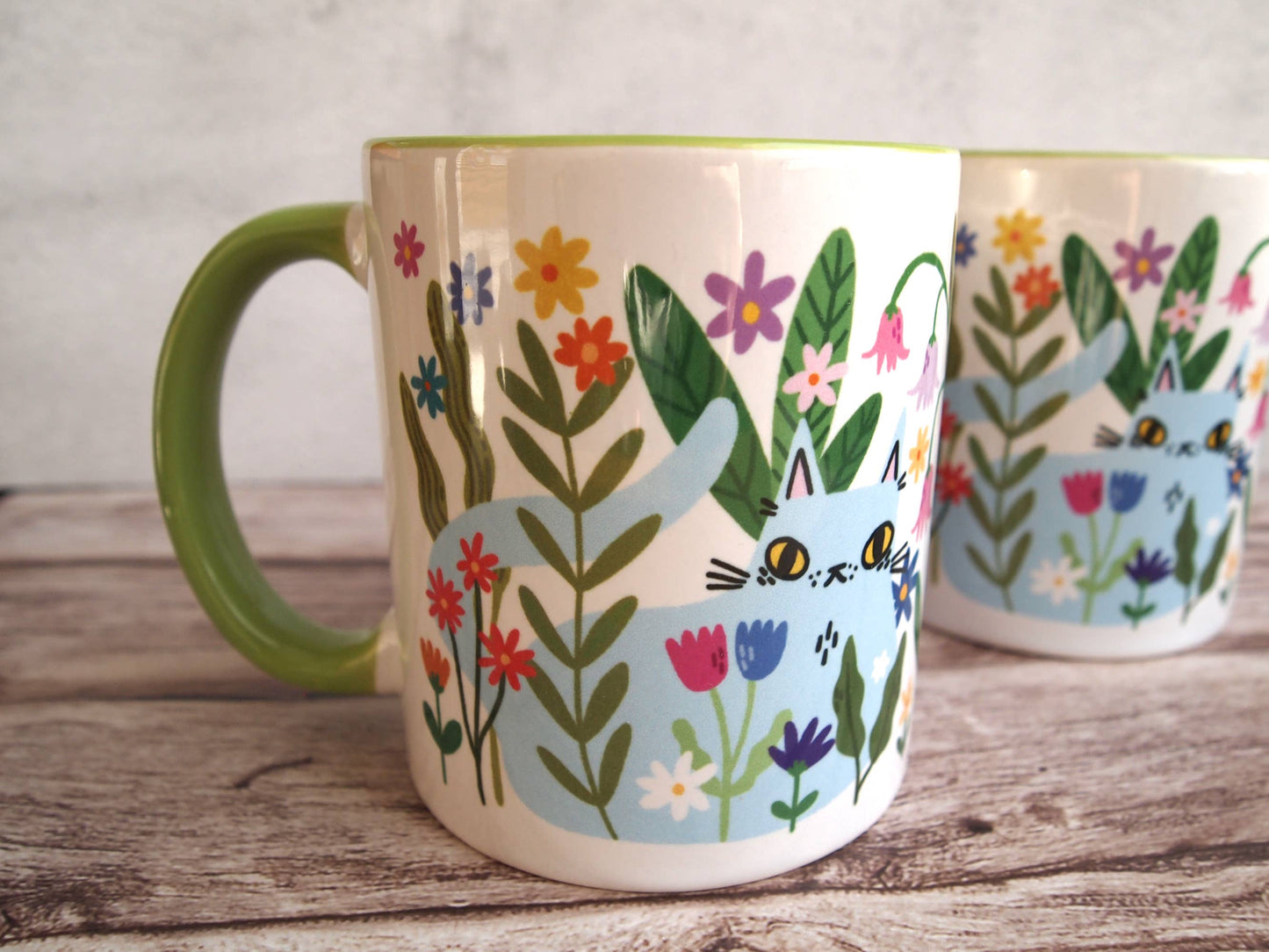Colourful cats with flowers illustrated coffee mug