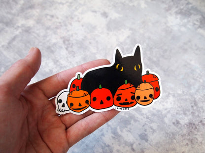 Black cat with pumpkins illustrated vinyl sticker