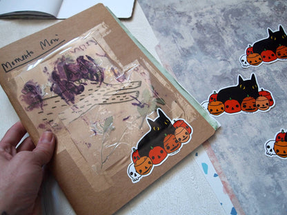 Black cat with pumpkins illustrated vinyl sticker